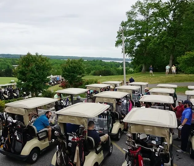 Carts lined up before a shotgun start at Above Par Golf